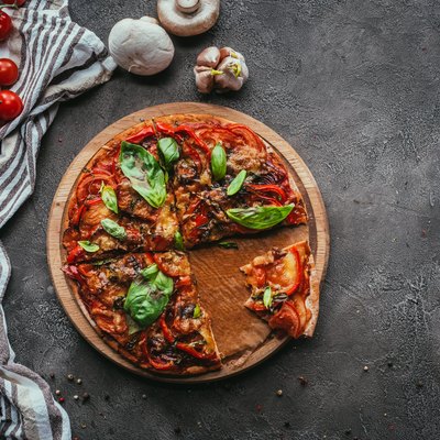 top view of delicious freshly baked pizza on concrete table