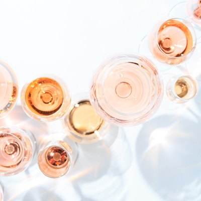 Many glasses of rose wine at wine tasting. Concept of rose wine and variety