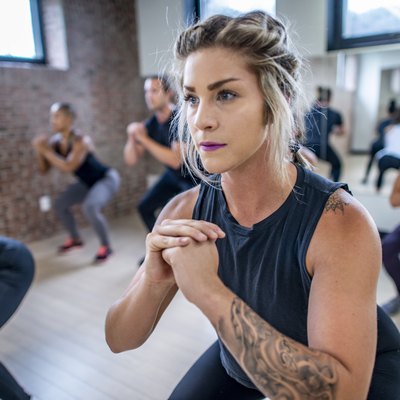 Diverse fitness class doing squats