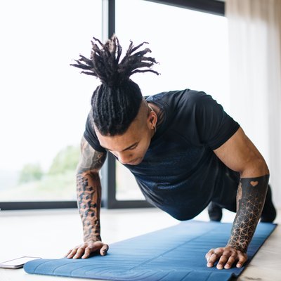 Man doing chest workout with push-ups at home