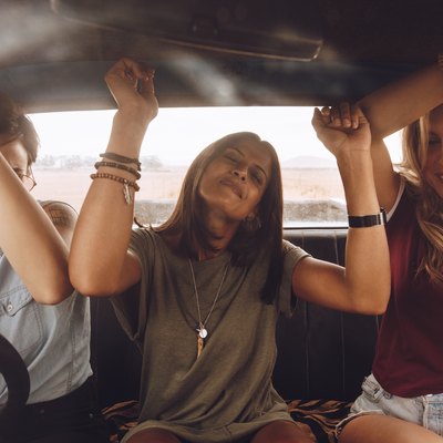 Friends enjoying traveling in the car