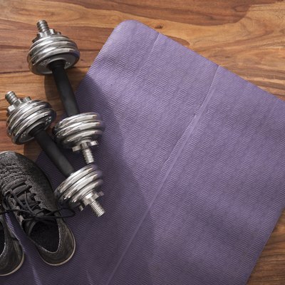 weights on an exercise mat for dumbbell exercises