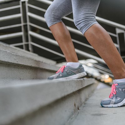 Legs and Shoes of a Jogger Running up a Staircase