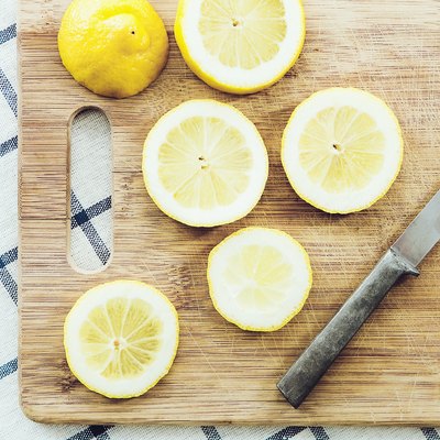Sliced lemon on wooden cutting board