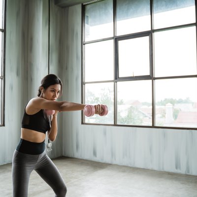 sporty woman with dumbbell doing weight exercise