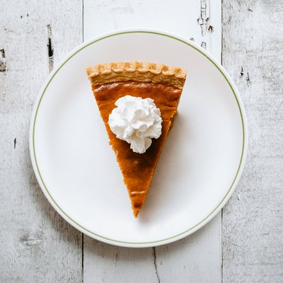 Pumpkin Pie Slice on Rustic Background