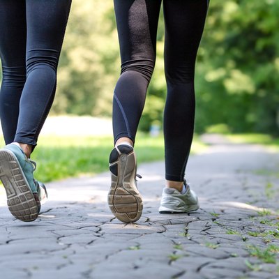 Female running feet in sport shoes