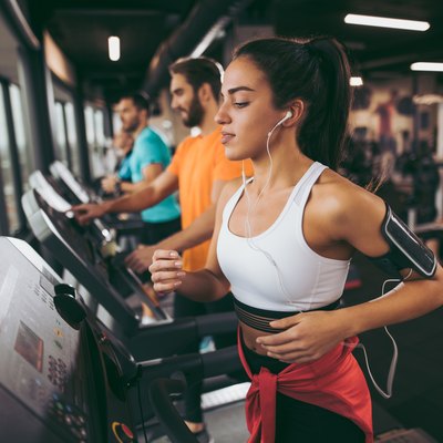Young woman exercising on treadmill