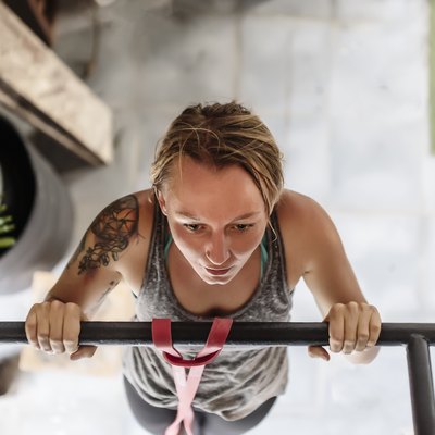 High angle view of woman doing pull-ups at gym