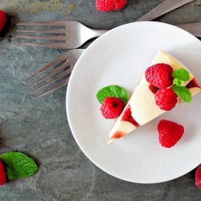 Raspberry cheesecake top view over a dark background