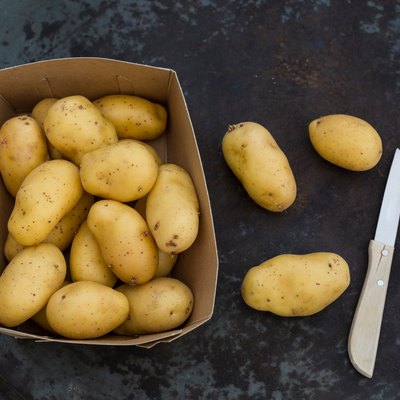 fresh ripe potatoes on table