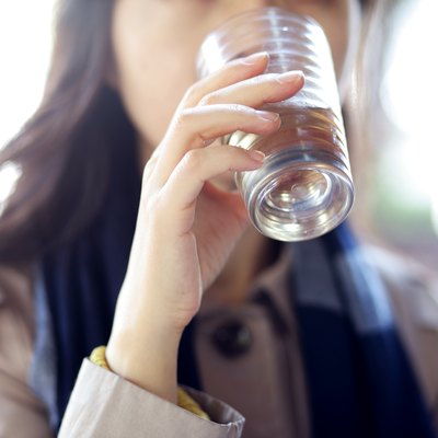 Woman drinking water in cafe