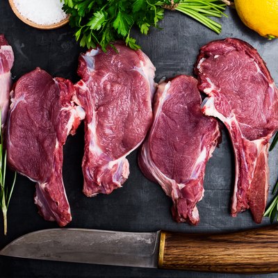 Fresh raw uncooked veal steaks with ingredients