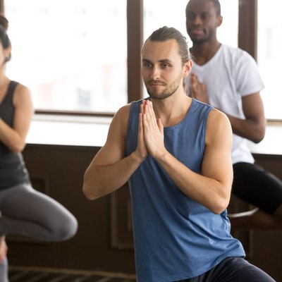 Group of sporty people in Tree pose