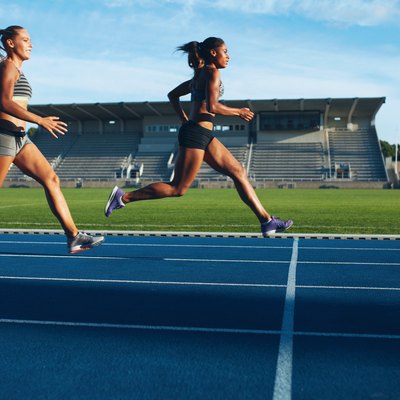 Athletes arrives at finish line on racetrack