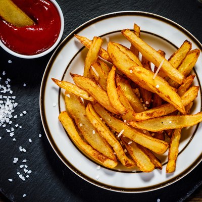 French fries on wooden background