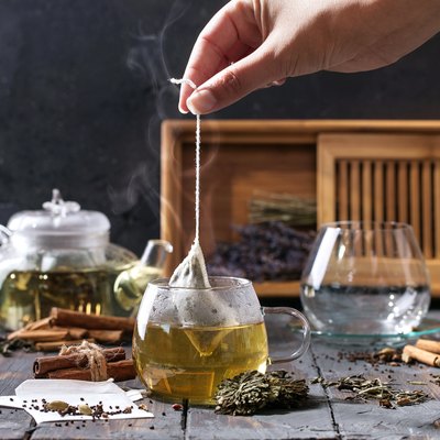 Cropped Image Of Woman Preparing Herbal Tea On Table