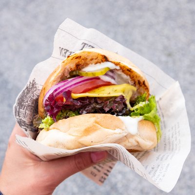 Cropped Hand Of Person Holding Burger