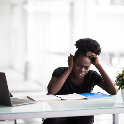 African american businesswoman or student with laptop computer and papers at office
