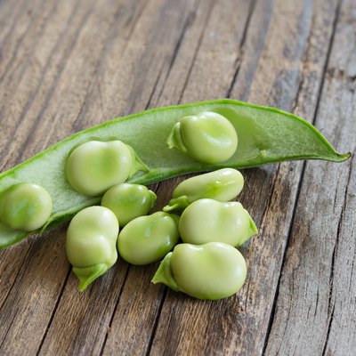 broad beans on wooden table