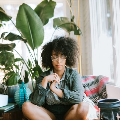 Young woman meditating at home