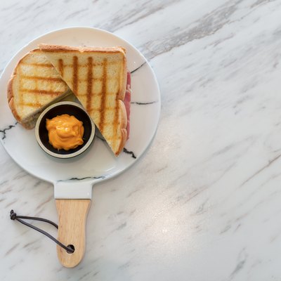 Ham cheese sandwich with custard sauce on marble