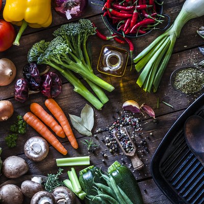 Fresh vegetables ready for cooking shot on rustic wooden table