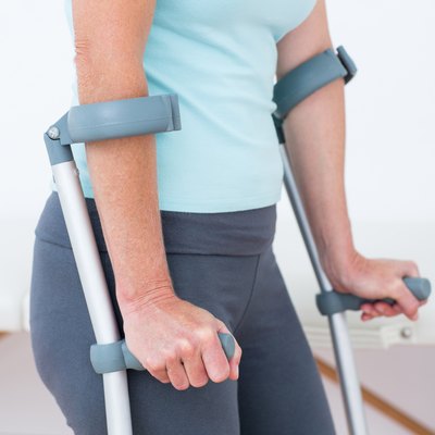 Woman standing with crutch