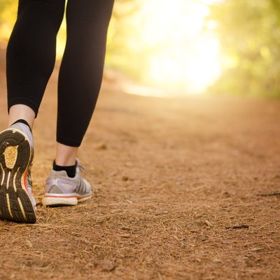 A woman with IBS taking a meditative walk in nature