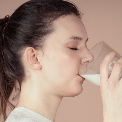 young woman drinking glass of milk