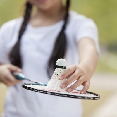 Chinese girl holding badminton racket and shuttlecock