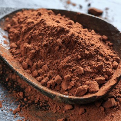 Close-Up Of Spoon With Cocoa Powder On Table