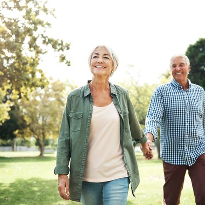 An older couple walking in the park