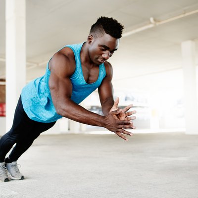Man performs a clap push-up while in mid-air.