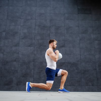 man doing lunges with kettlebell for a butt workout