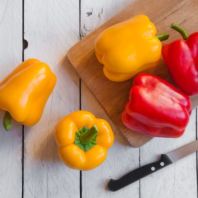 Fresh bell peppers on cutting board