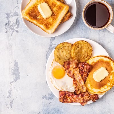 Healthy Full American Breakfast with Eggs Bacon Pancakes and Latkes
