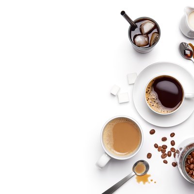 Different types of coffee and ingredients over white background with copy space