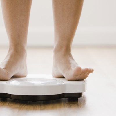 Caucasian woman's feet standing on scale