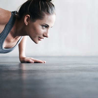 A woman doing pushups to build muscle
