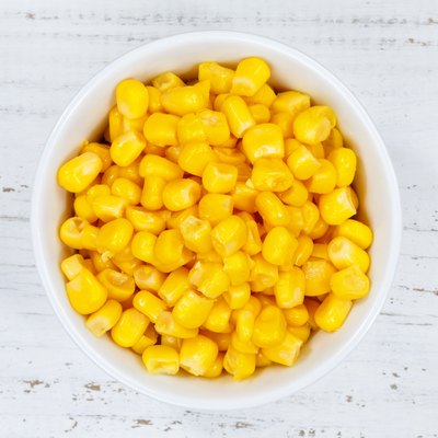 Corn grains grain from above bowl wooden board
