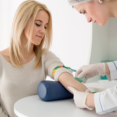 Woman and doctor preparing for blood test