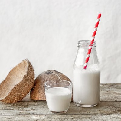 Coconut milk and coconut fruit cut in half