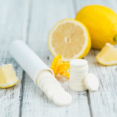 Vitamin C Tablets on wooden background; selective focus