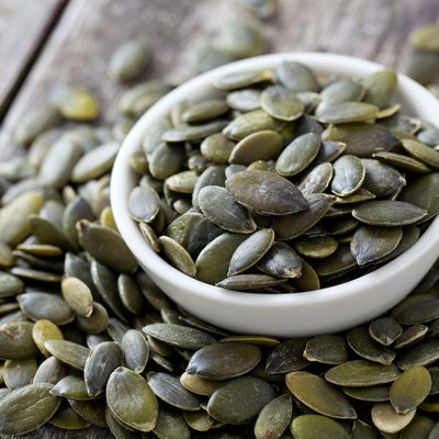 pumpkin seeds on wooden surface