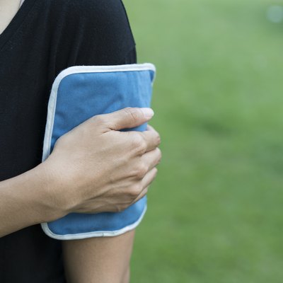 woman applying cold pack on her arm