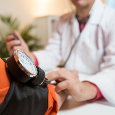 Senior woman getting low blood pressure checked by doctor