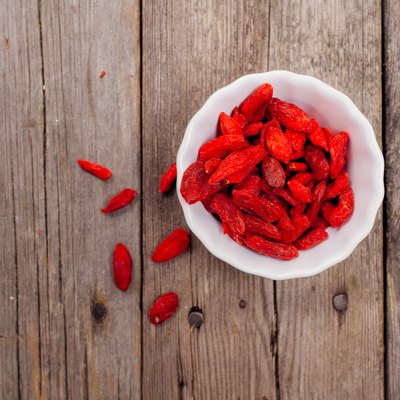Gojiberries in a bowl on wooden background
