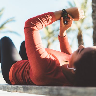 Sportswoman checking heart rate on smartwatch