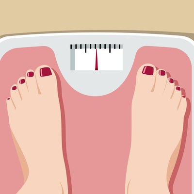 Feet on bathroom scale conveying obesity health risks